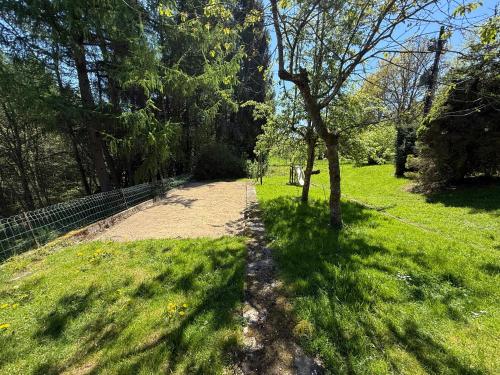 a dirt path in a field with trees and grass at Aux 3 Canards in Stoumont