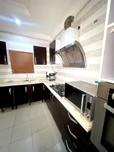 a kitchen with a sink and a stove top oven at luxury 2 bedroom apt in Lekki in Lekki