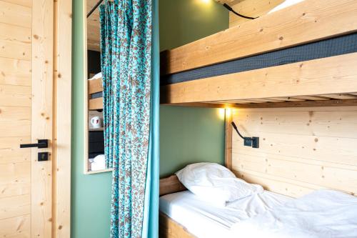 a bedroom with two bunk beds in a house at Appartement Les Menuires in Les Menuires