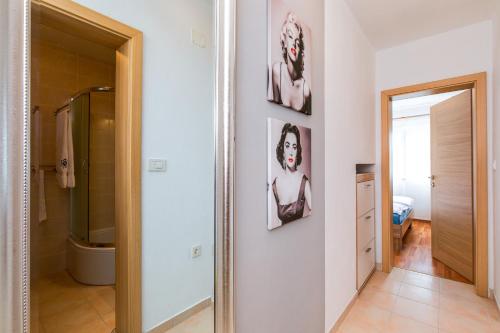 a bathroom with a toilet and a mirror at Kuća Koza-Apartment Marijana in Punat