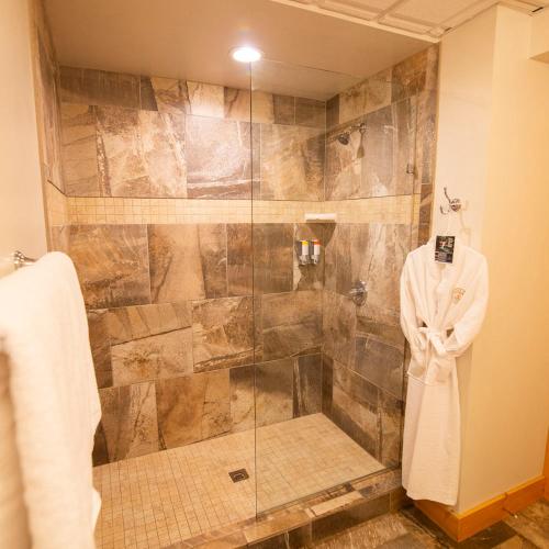 a shower with a glass door in a bathroom at Lilypad - by The Chalets in Logan