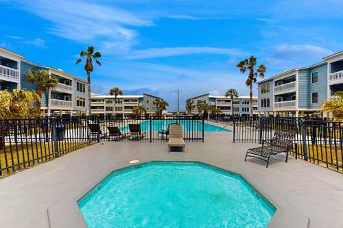 a swimming pool at a resort with chairs and condos at Sea Oats E106 in Gulf Shores