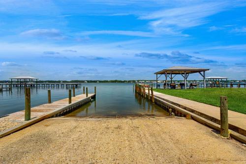 a dock with a pavilion on a body of water at Sea Oats E106 in Gulf Shores