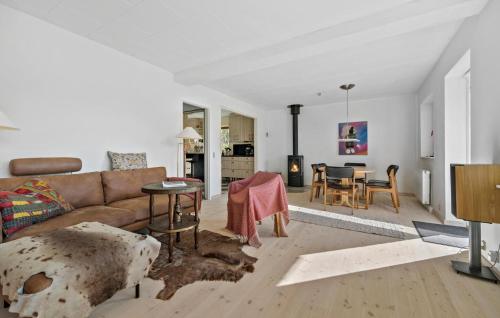 a living room with a couch and a table at 3 Bedroom Cozy Home In Rørvig in Rørvig