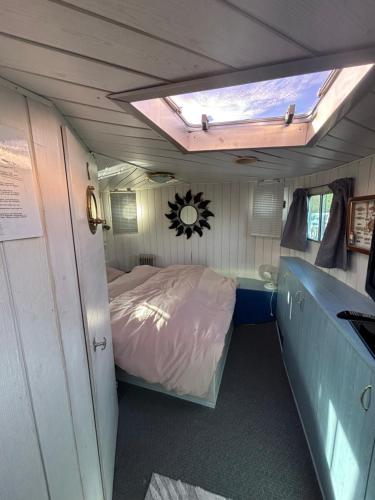 a small room with a bed and a window at La chambre sur l eau in Pont-de-Vaux