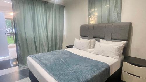 a bedroom with a large bed and a window at Central Perk Guesthouse in Pretoria