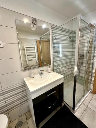 a bathroom with a sink and a shower at Costa da Caparica Beach in Costa da Caparica
