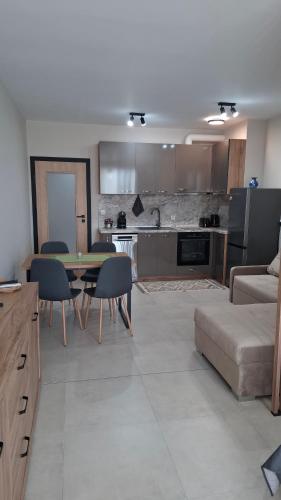 a kitchen and living room with a table and chairs at DNV Apartments 30 Varna in Varna City