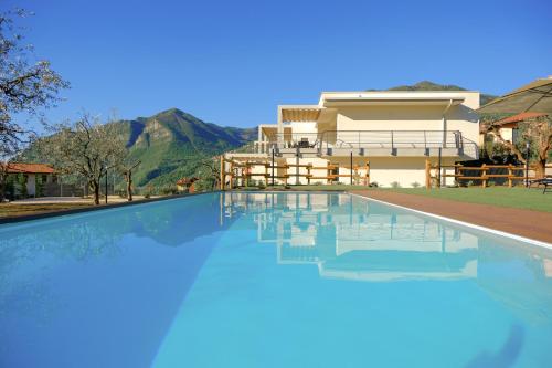 a house with a swimming pool in front of a house at Costa Blu-Pool and Terrace overlooking the lake in Riva di Solto