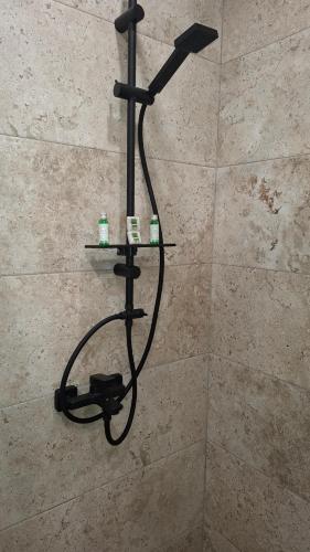 a shower in a bathroom with a shower head at DNV Apartments 30 Varna in Varna City