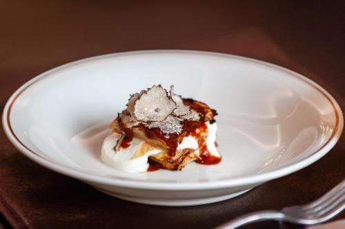 a white plate with a piece of cake and ice cream at Hotel Delle Nazioni in Rome