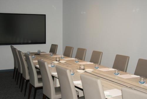a conference room with a long table and chairs at Holiday Inn Telford Ironbridge by IHG in Telford
