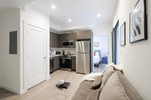 a living room with a couch and a kitchen at Unit 2 Cozy One bed in the heart of Dc in Washington, D.C.