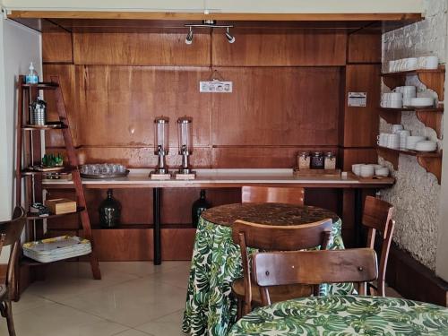 a kitchen with a table and chairs and a sink at Hotel Cano in Iquique