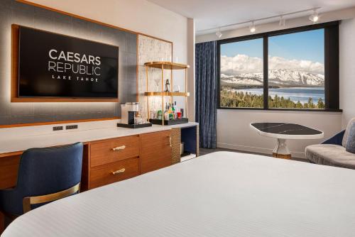 a room with a bed and a desk and a window at Caesars Republic Lake Tahoe in Stateline