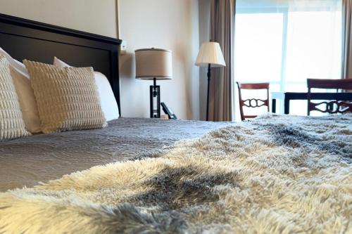 a bedroom with a large bed with a furry blanket at Mountain Inn Studio 92 with Wintergreen Advantage in Wintergreen