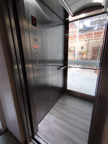 an empty refrigerator in a room with a window at Hotel Cano in Iquique