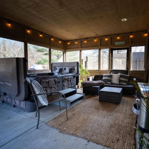 a living room with a stove and a couch at Rockhouse - by The Chalets in Logan