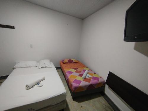 Postel nebo postele na pokoji v ubytování HOTEL LA FONTANA