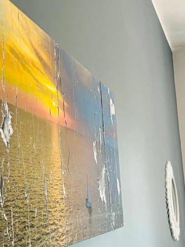 a painting is hanging on a wall at B&B DOÑA FLOR in Parabita