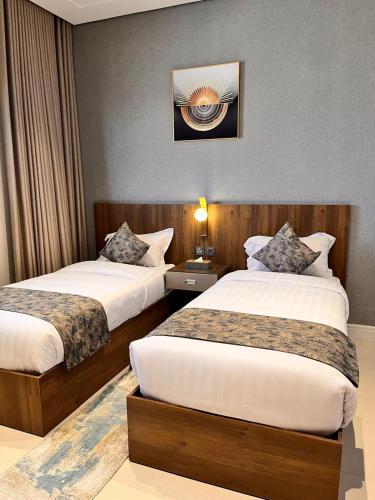 شقق رسن سويت الفندقية - Rasan Suite hotel Apartmentにあるベッド
