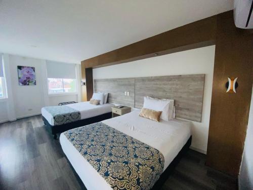 Voodi või voodid majutusasutuse Hotel Metropolis Plaza Cali toas