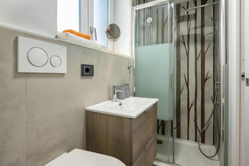 a bathroom with a toilet and a sink and a shower at Favola Rosa in Alghero