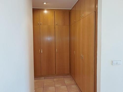 a closet with wooden cabinets in a room at Villa ALVAMAR in Blanes