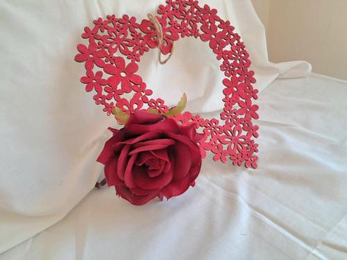 a red rose on a white dress with a chain at Villa ALVAMAR in Blanes
