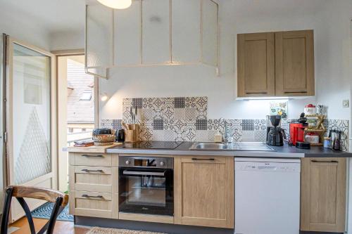 a kitchen with a sink and a stove top oven at Maloan, gite avec piscine in Saint-Julien-de-Lampon