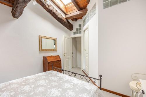 a bedroom with a bed and a wooden ceiling at Romantica Residenza - Borgo Castello di Serravalle in Castello di Serravalle