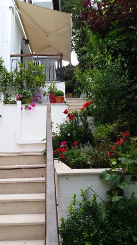 a set of stairs leading to a house with flowers at Mavra Studios in Lygia