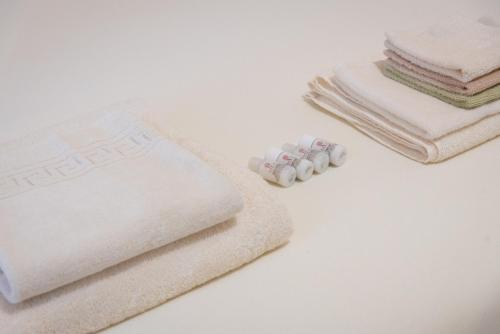 a pile of towels sitting on a counter next to towels at Soraya - Suites & Apartments in Palau