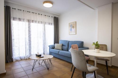 a living room with a blue couch and a table at Archena ID300 in Villanueva de Río Segura
