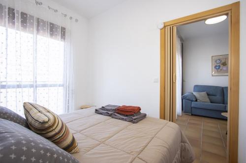 a bedroom with a bed and a blue couch at Archena ID300 in Villanueva de Río Segura
