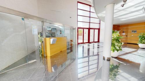 a hallway of a building with potted plants at Archena ID300 in Villanueva de Río Segura