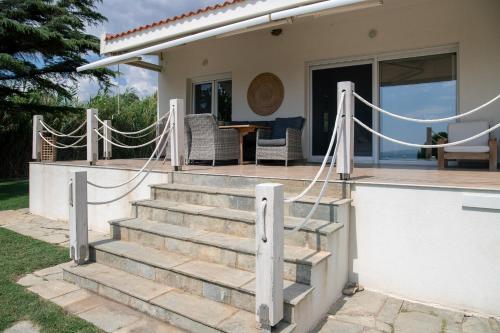 a set of stairs leading to a house at Oceana - Exclusive Beachfront Villa with Private Pool and BBQ by GG in Alexandroupoli