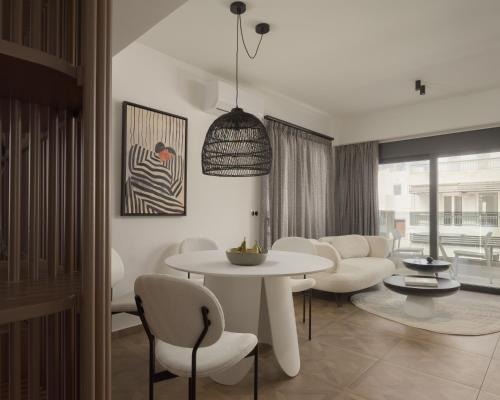 a living room with a white table and chairs at Allegro Suites in Rethymno Town
