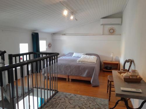 a bedroom with a bed and a table in a room at Sous le tilleul in Montfaucon