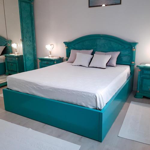 a bedroom with a blue bed with two night stands at Villa Royal Natura - Private Villa in Pombal in Pombal