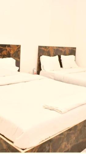 two beds sitting next to each other in a room at Hotel shiva home in Banāras Cantonment