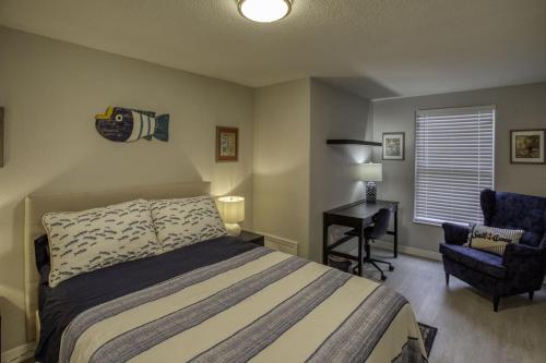 a bedroom with a bed and a desk and a chair at River Rats Rest in Homosassa