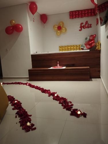 a room with a bunch of balloons and a string of roses at Bajo la luna hotel in Medellín