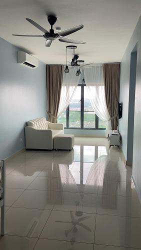 a living room with a couch and a ceiling fan at Tulips Cozy Homestay For You in Shah Alam