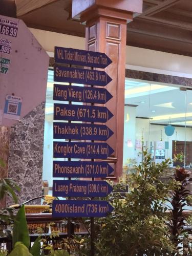 a street sign with many signs in a building at Vientiane Luxury Hotel in Vientiane