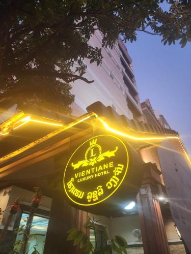 a yellow sign on the side of a building at Vientiane Luxury Hotel in Vientiane