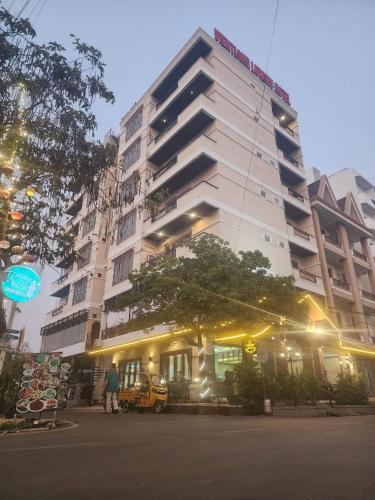 a man standing in front of a tall building at Vientiane Luxury Hotel in Vientiane