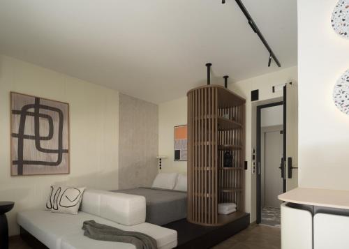 a bedroom with a bed and a couch in it at Allegro Suites in Rethymno Town