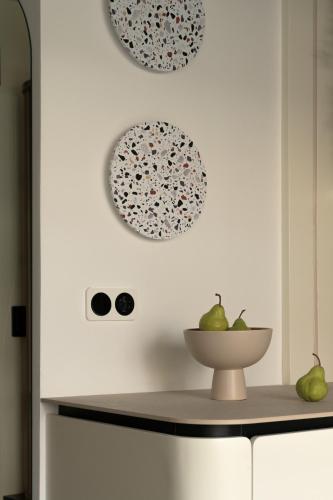 a kitchen with plates on the wall and a bowl of pears at Allegro Suites in Rethymno Town