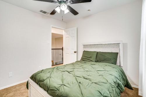 a bedroom with a green bed with a ceiling fan at 2 Mi to Old Town Spacious Burleson Vacation Home in Burleson